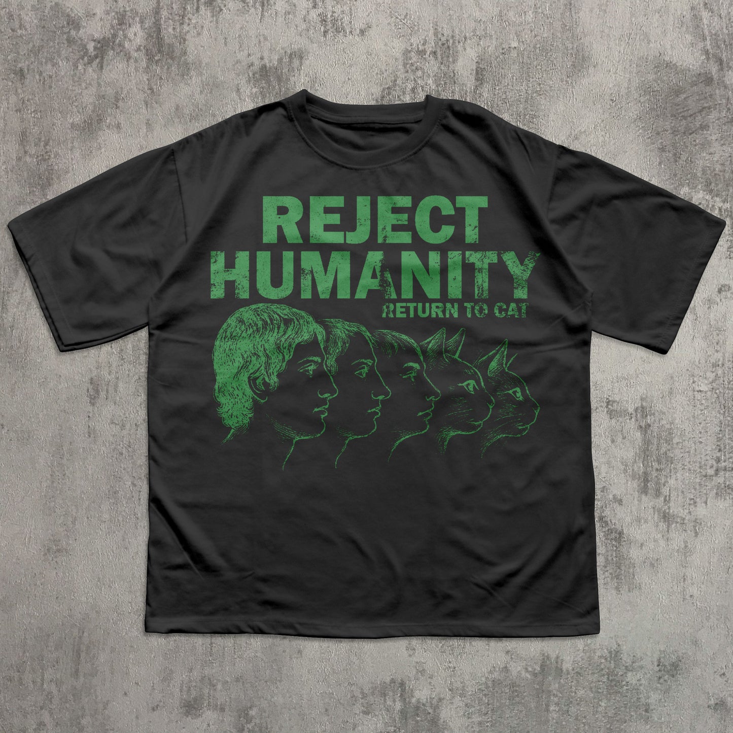 Black t-shirt with green graphic and text 'REJECT HUMANITY RETURN TO CAT' on a textured gray background