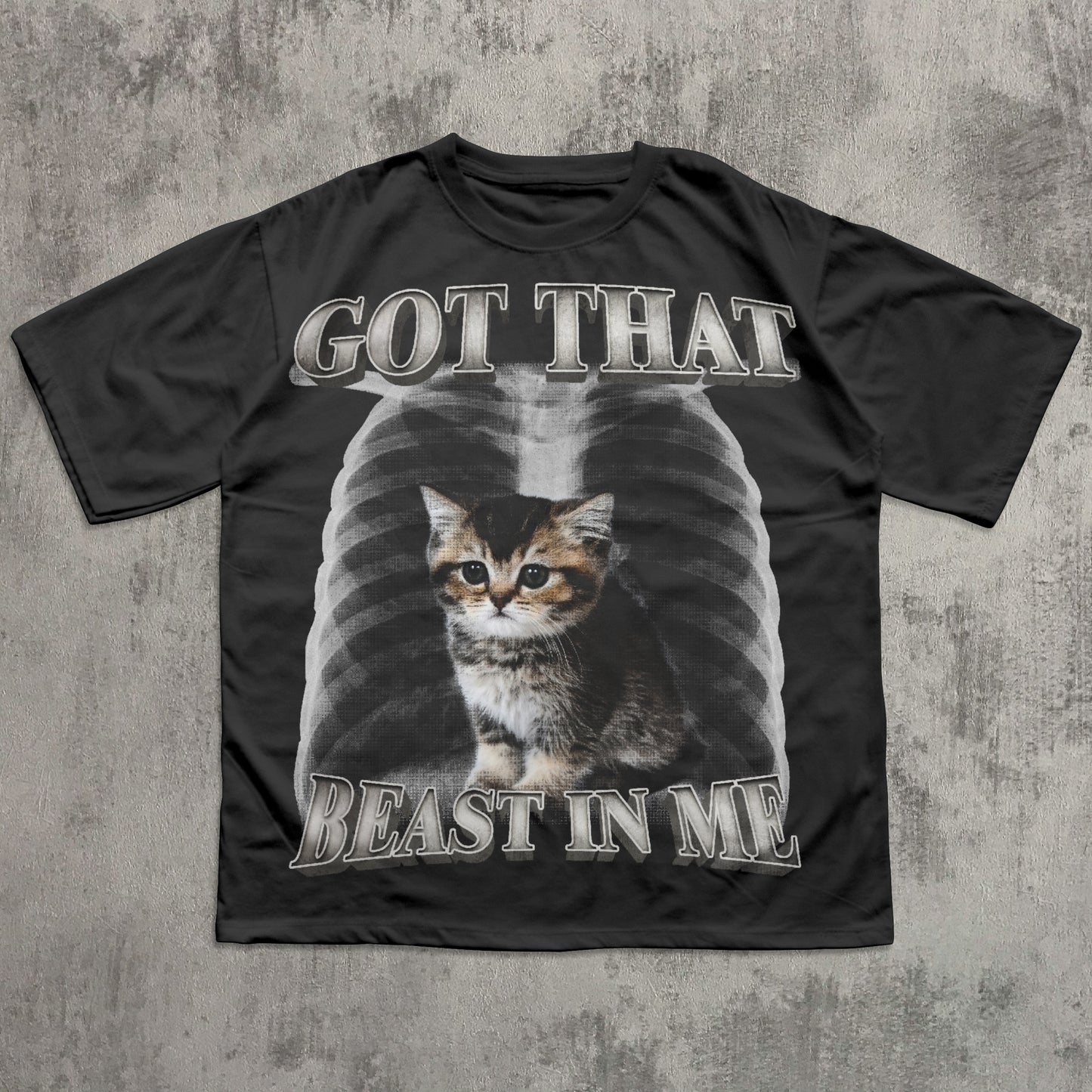 Black t-shirt with a cat graphic and text on a textured gray background
