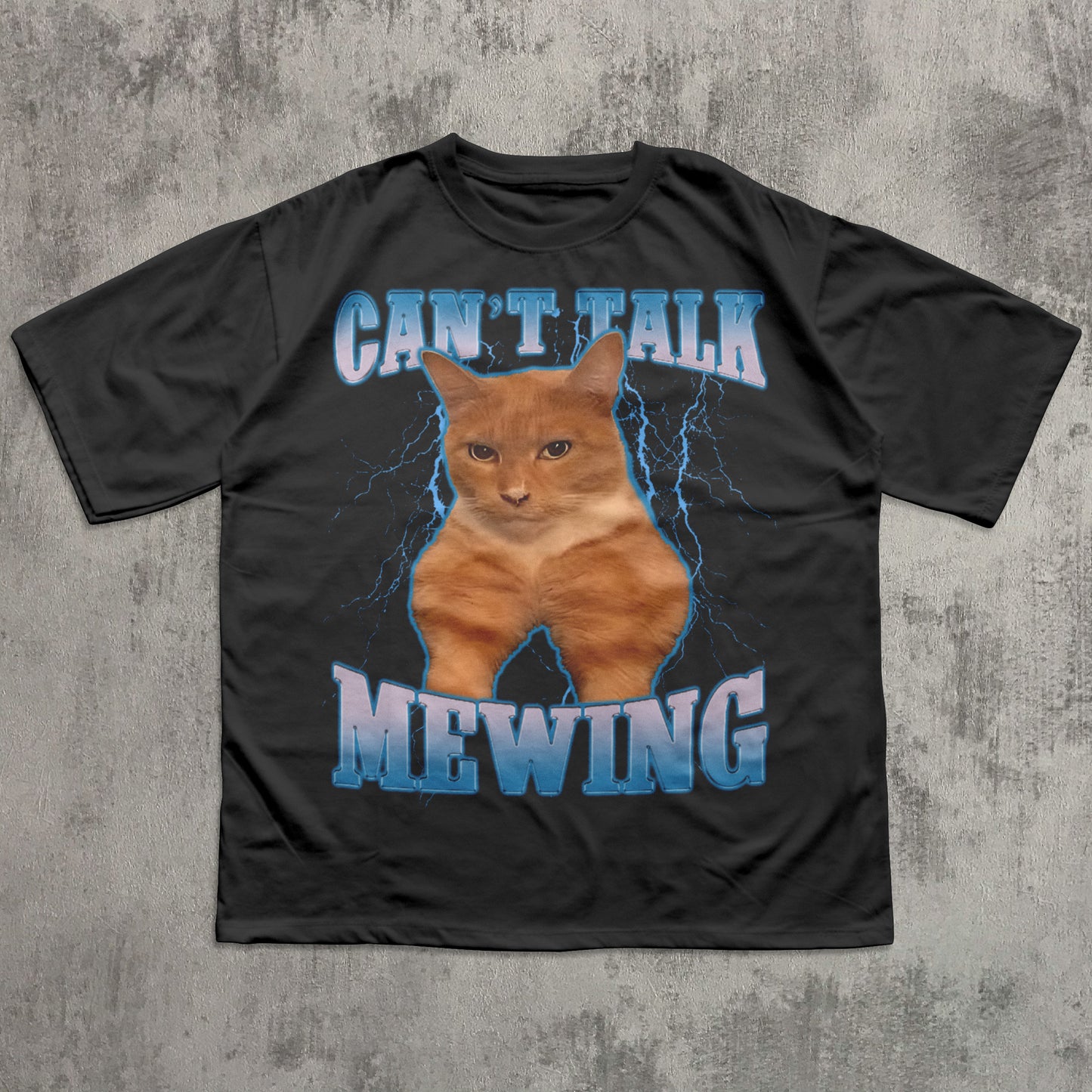 funny Black t-shirt with a cat graphic and text 'CAN'T TALK MEOWING' on a textured gray background