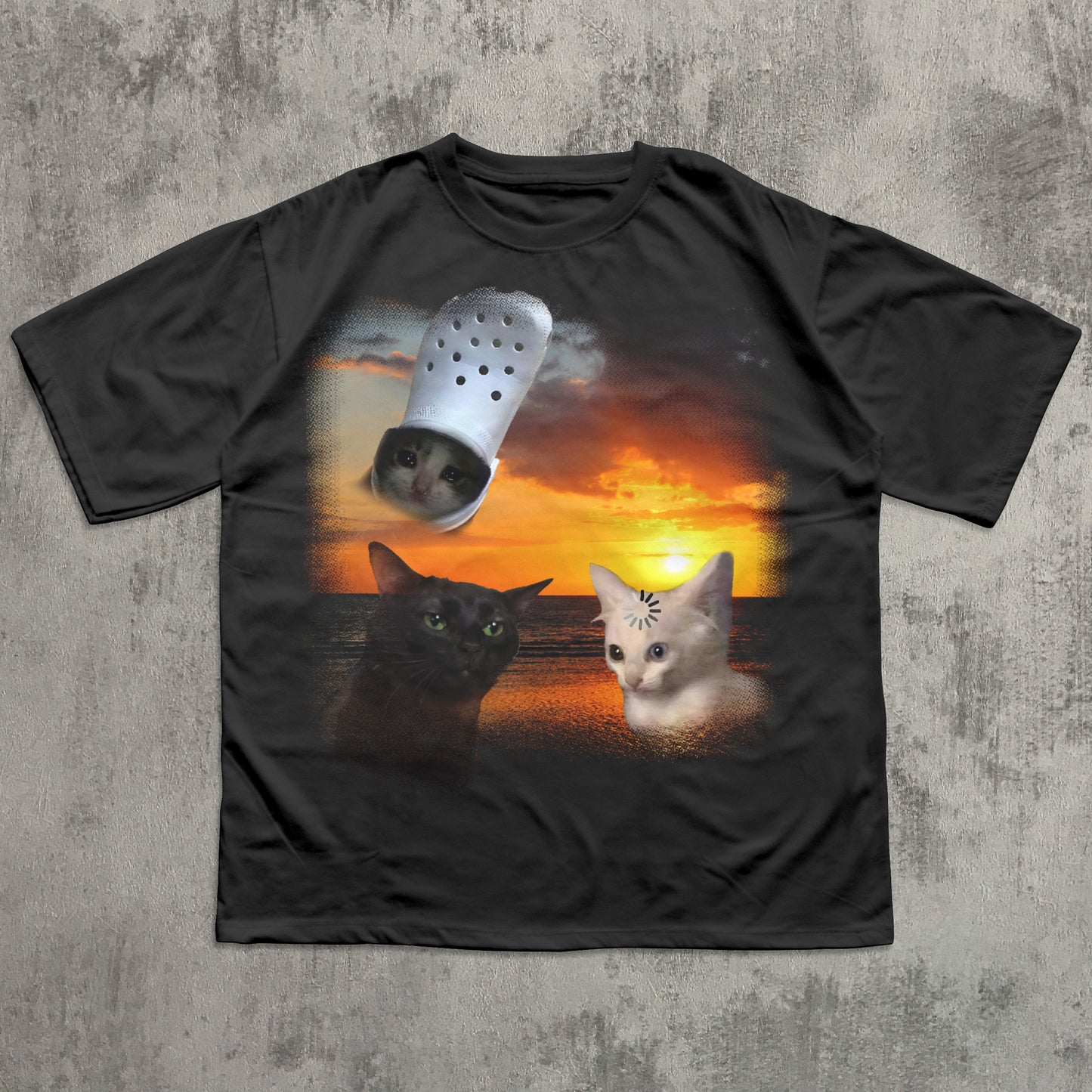 Black t-shirt with a graphic of two cats and a Croc shoe on a sunset background