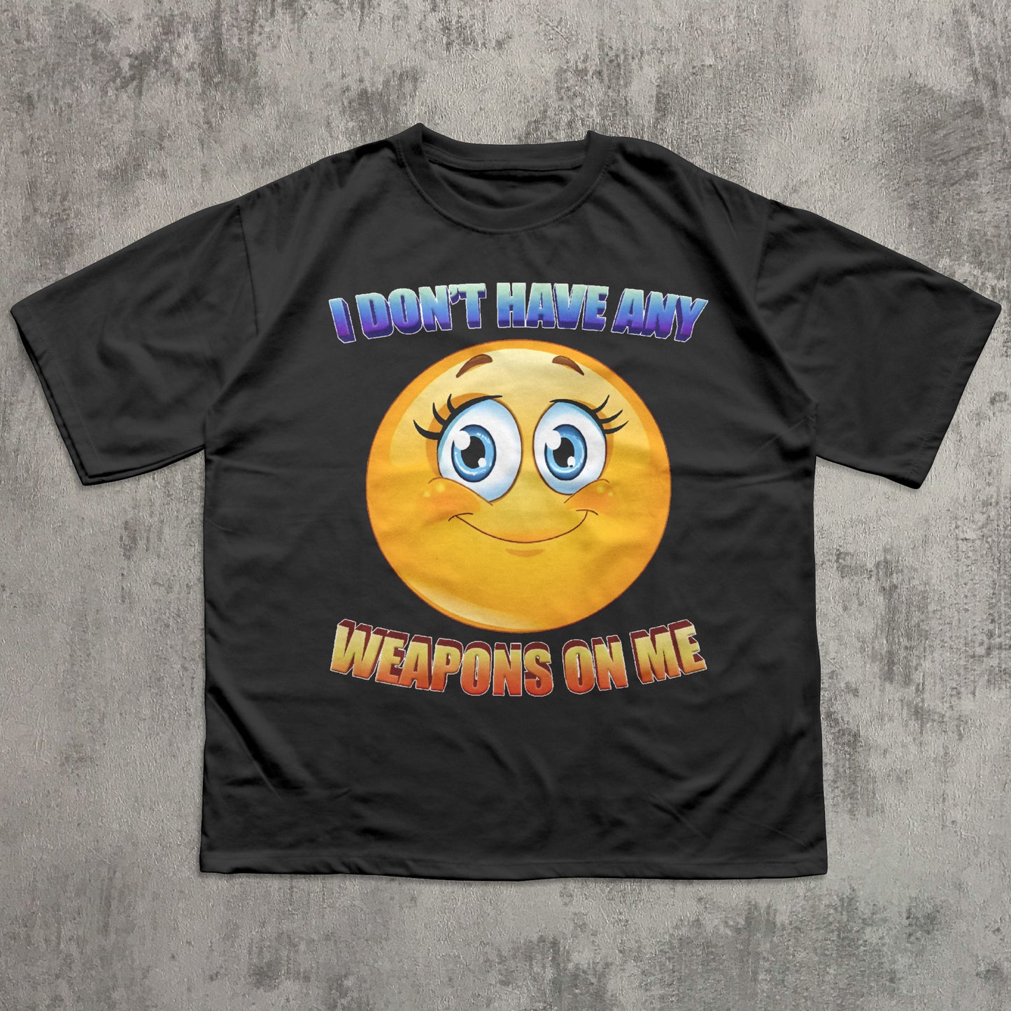 Black t-shirt with a smiley face and text on a concrete surface