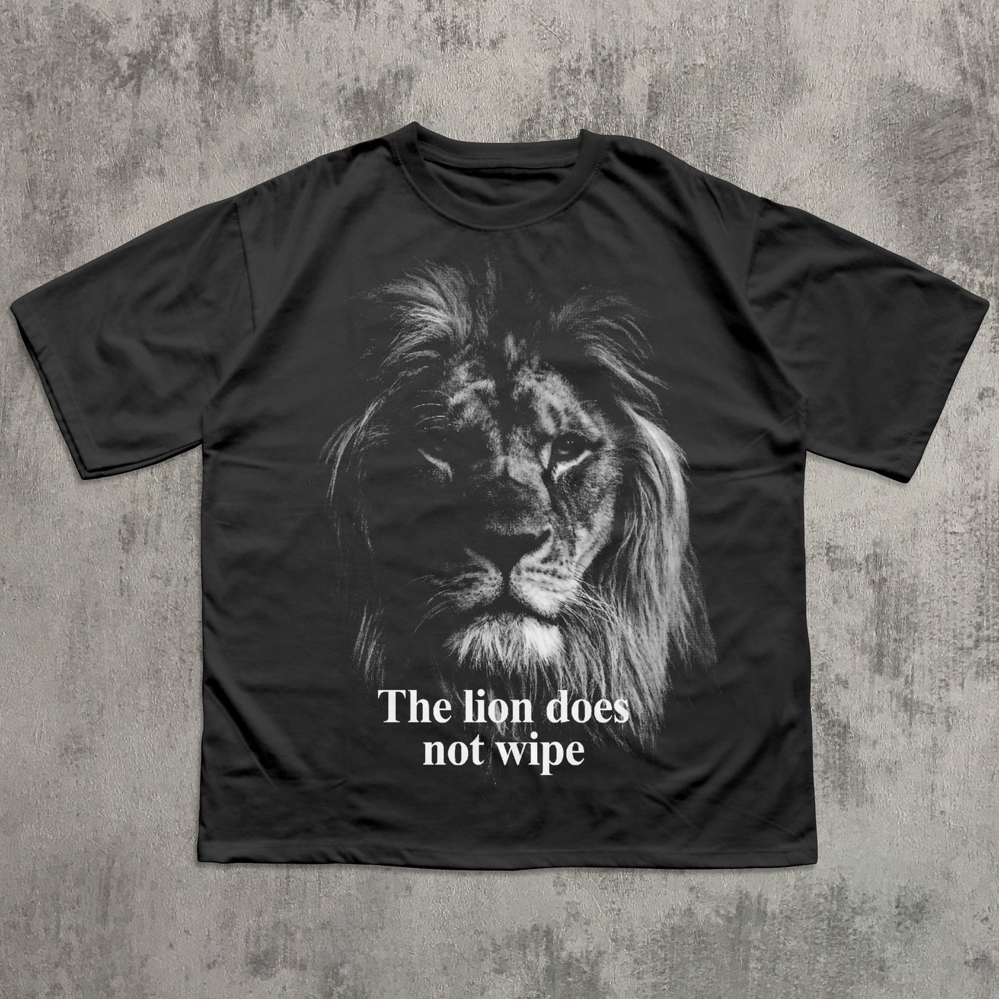 Black t-shirt with a lion graphic and text 'The lion does not wipe' on a textured gray background
