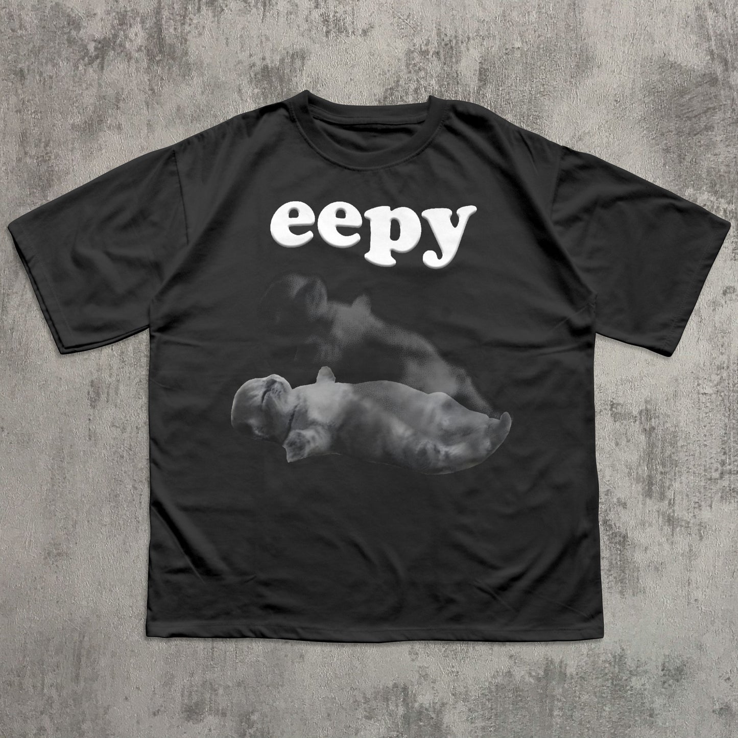 Black t-shirt with 'eepy' text and cat graphic on a textured gray background