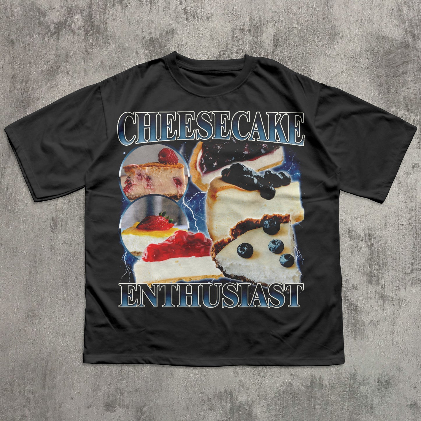 Black t-shirt with cheesecake graphic and text on a textured gray background
