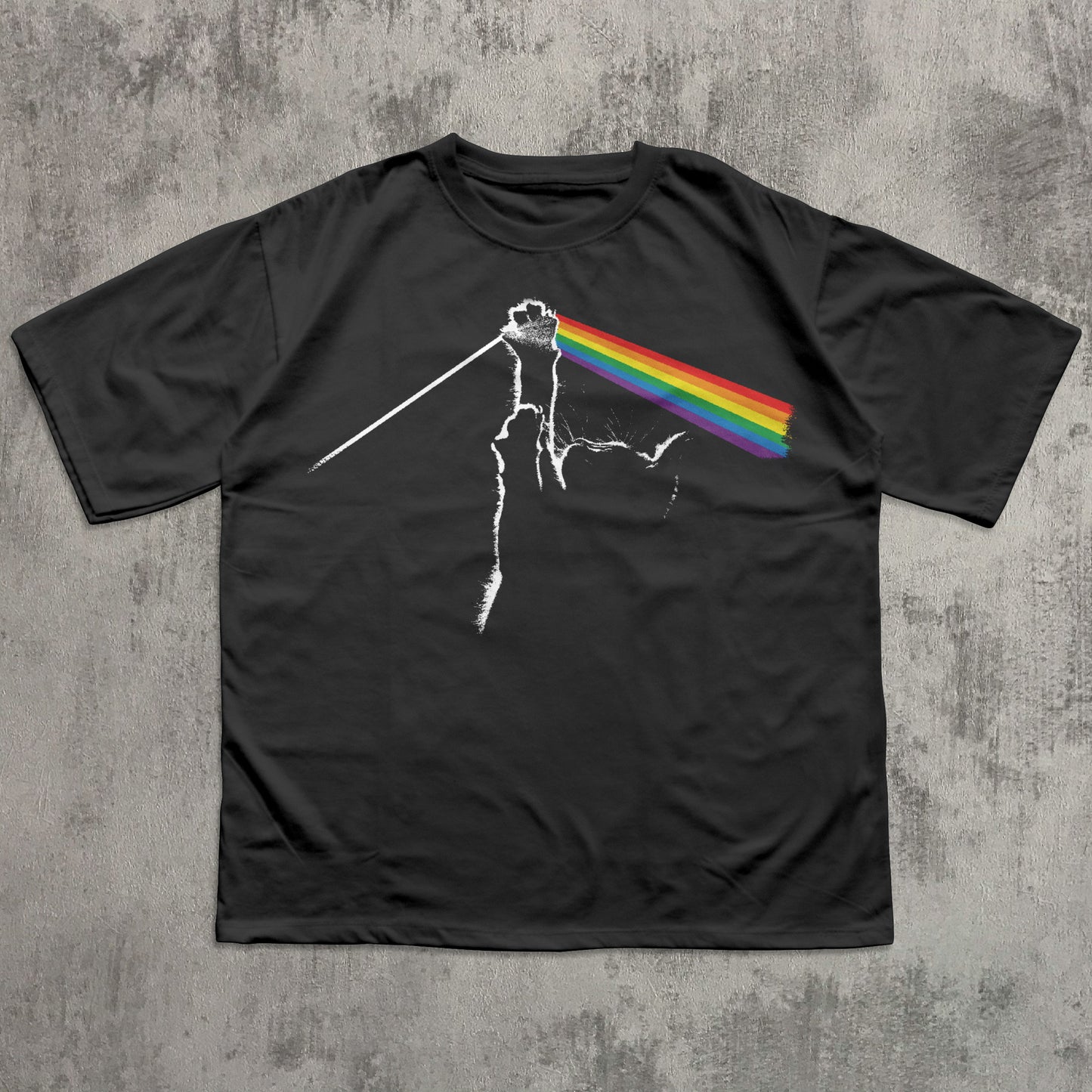 Black t-shirt with a graphic design of a rainbow on a concrete surface