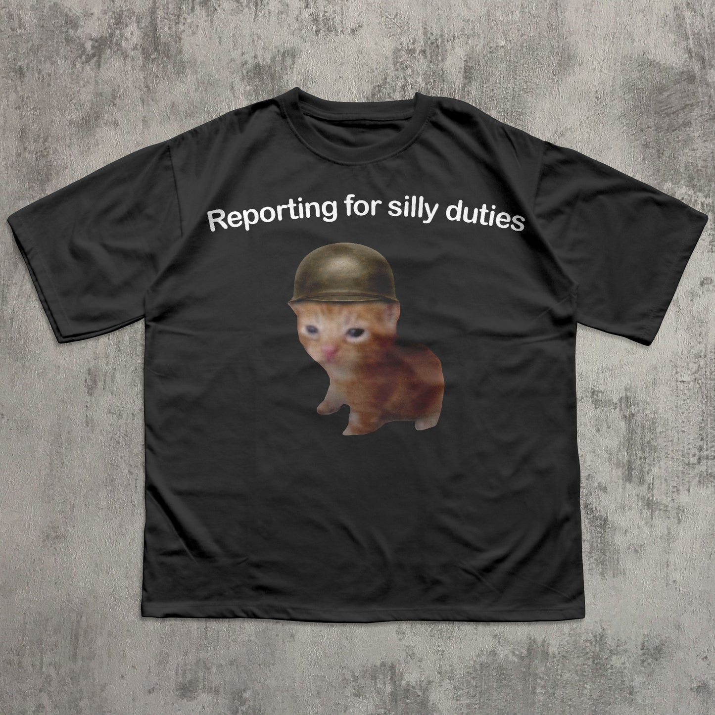 Black t-shirt with a Cat wearing a helmet and text 'Reporting for silly duties' on a textured gray background