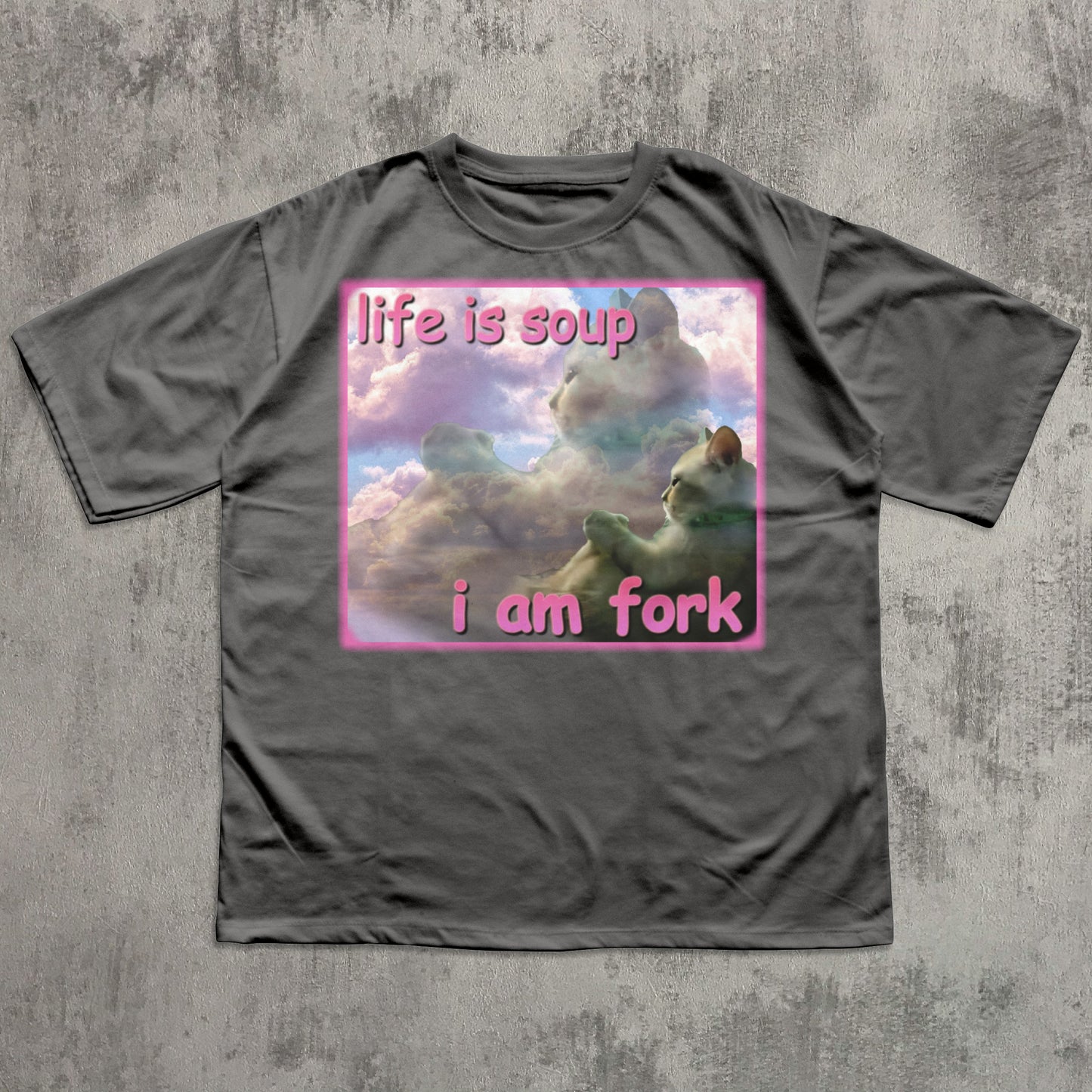 Gray t-shirt with a graphic design of a cat in clouds and text 'life is soup i am fork' on a textured gray background.