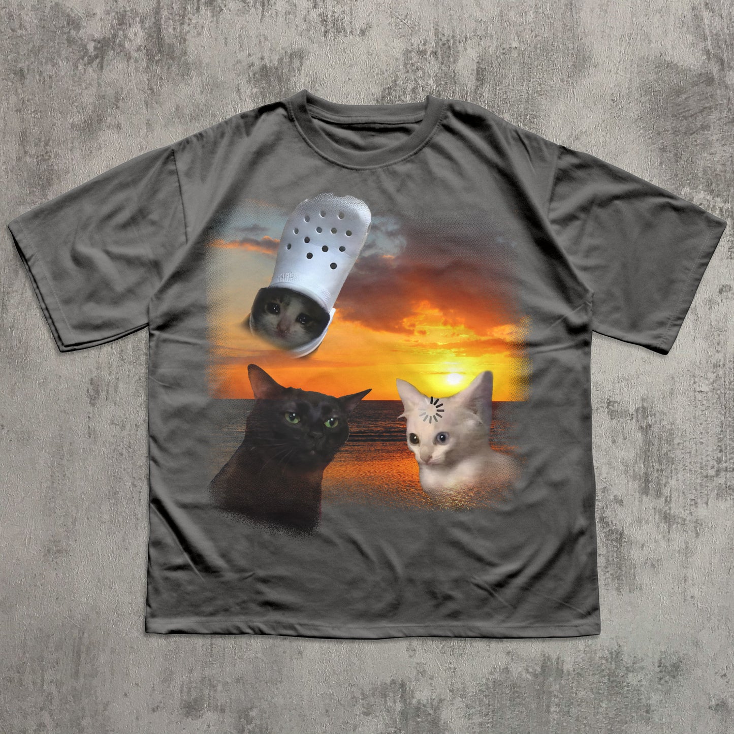 Gray t-shirt with a graphic of two cats and a Crocs shoe on a sunset background