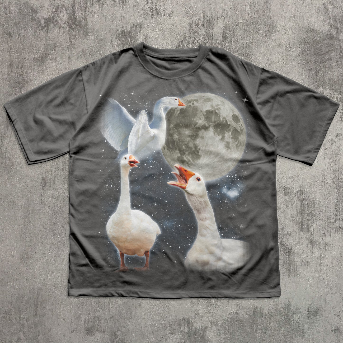 Gray t-shirt with a graphic of three geese and a moon on a textured gray background