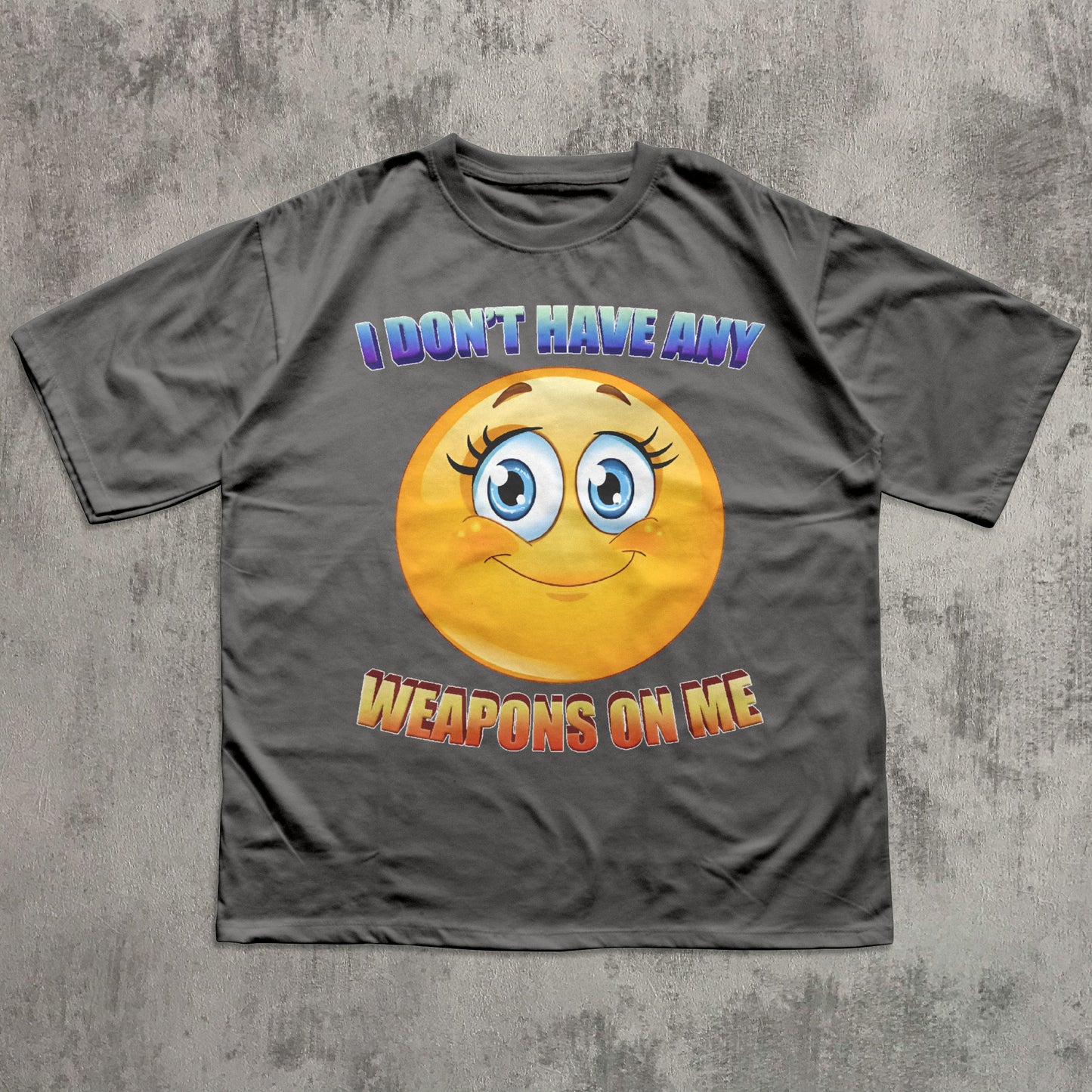 Gray t-shirt with a smiley face and text on a textured gray background