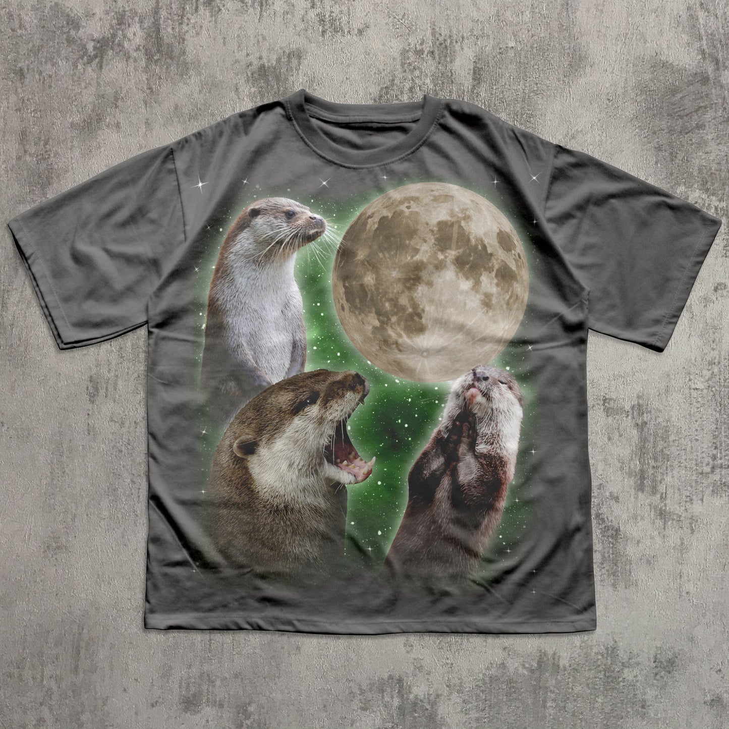 T-shirt with otter and moon design on a textured gray background