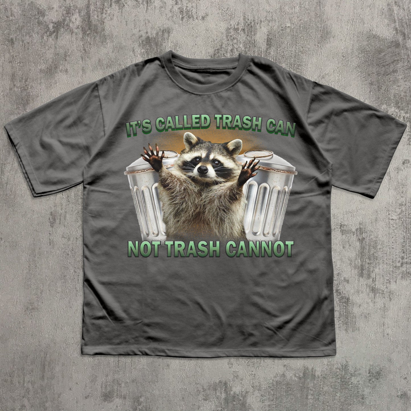 Gray t-shirt with a raccoon graphic and text on a textured gray background