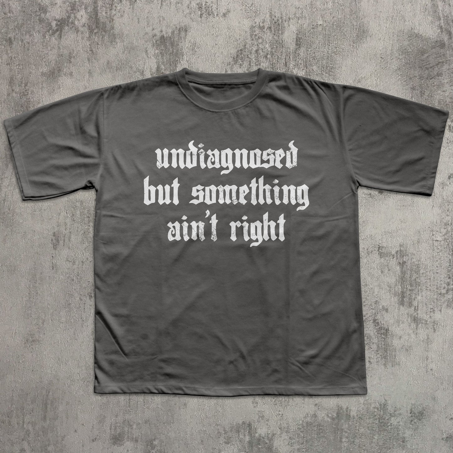 Gray t-shirt with white text on a textured gray background
