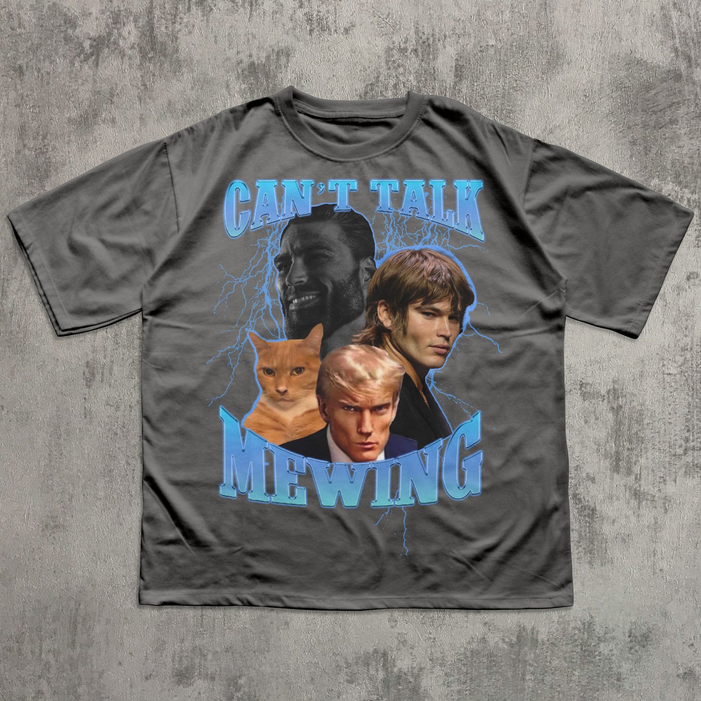 Gray t-shirt with graphic design of characters and text 'Can't Talk Mewing' on a textured gray background