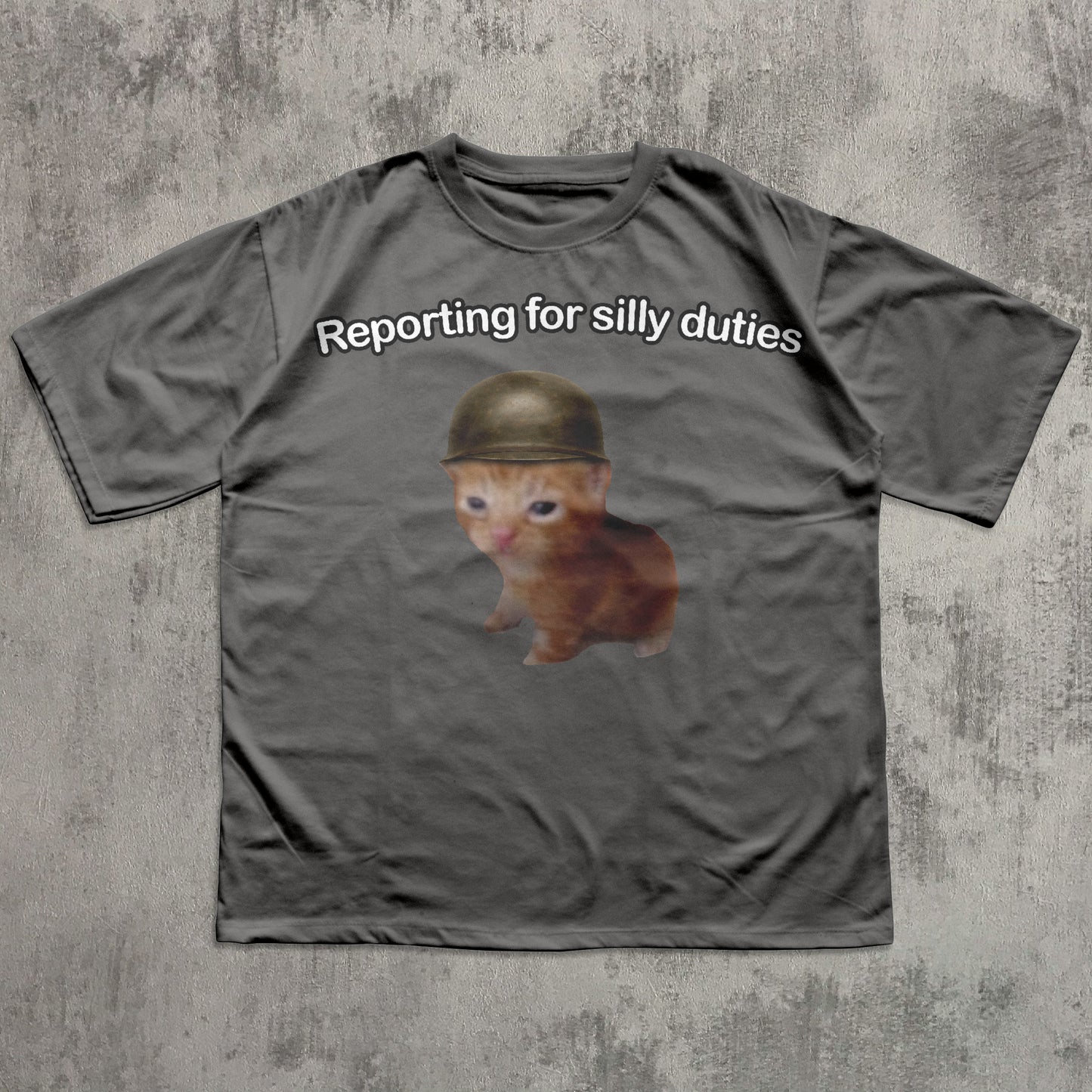 Gray t-shirt with a Cat wearing a helmet and text 'Reporting for silly duties' on a textured gray background