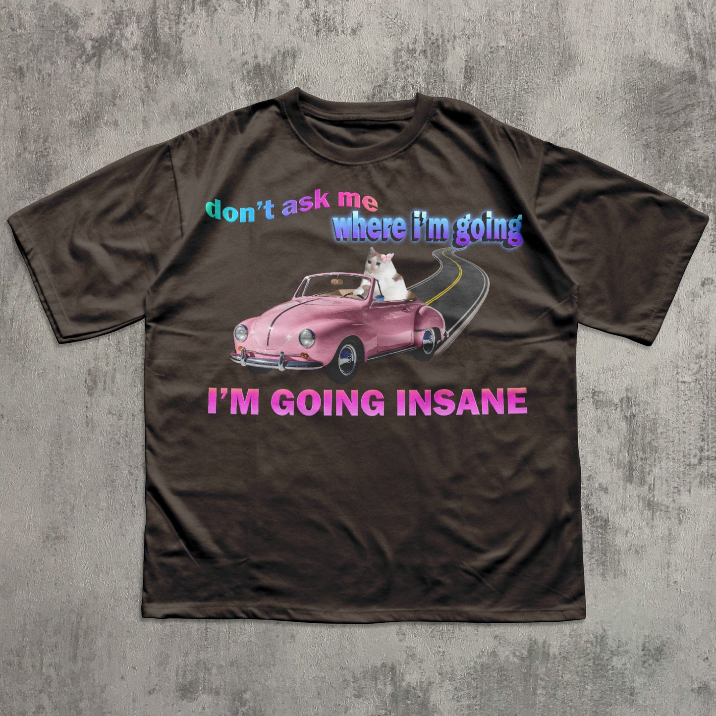 Funny cat meme brown t-shirt with a graphic of a pink car and text on a gray background