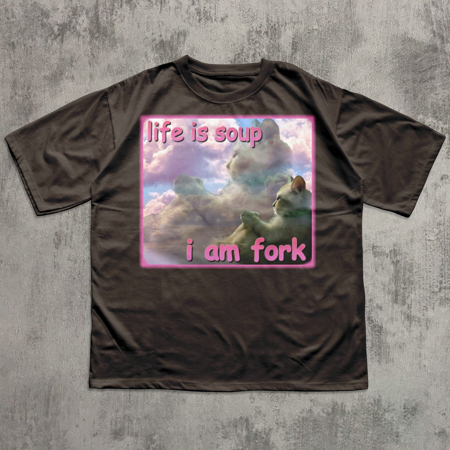 Brown t-shirt with a graphic design and text on a textured gray background