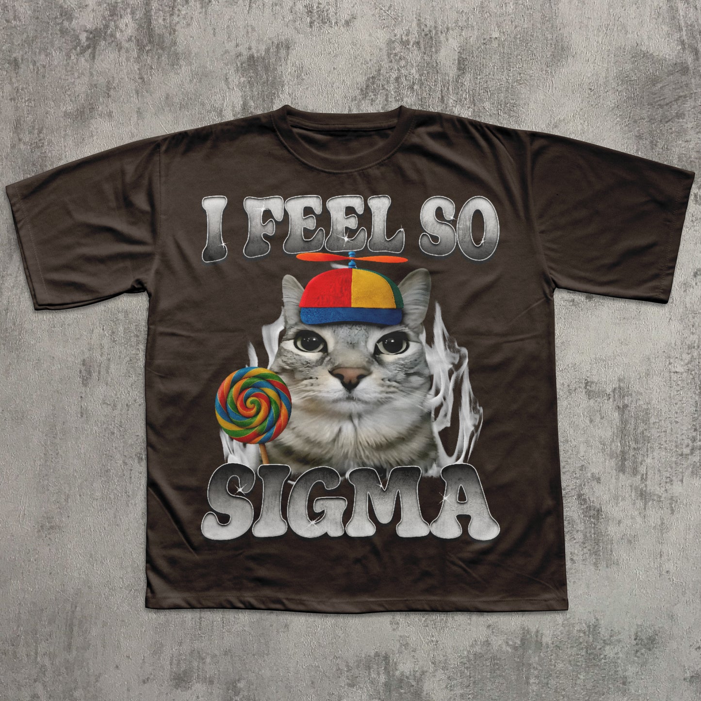 Brown t-shirt with a cat graphic and text 'I Feel So Sigma' on a textured gray background