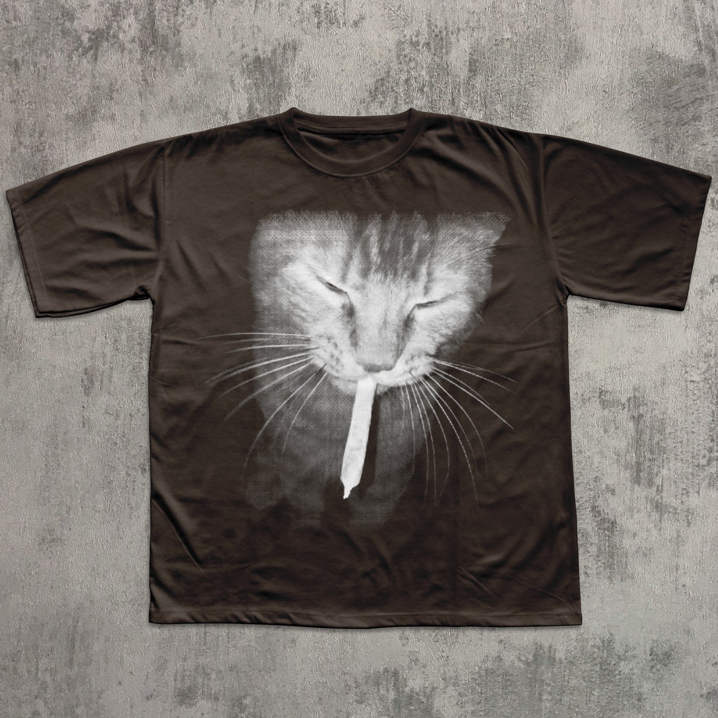 Brown t-shirt with a cat face design on a textured gray background