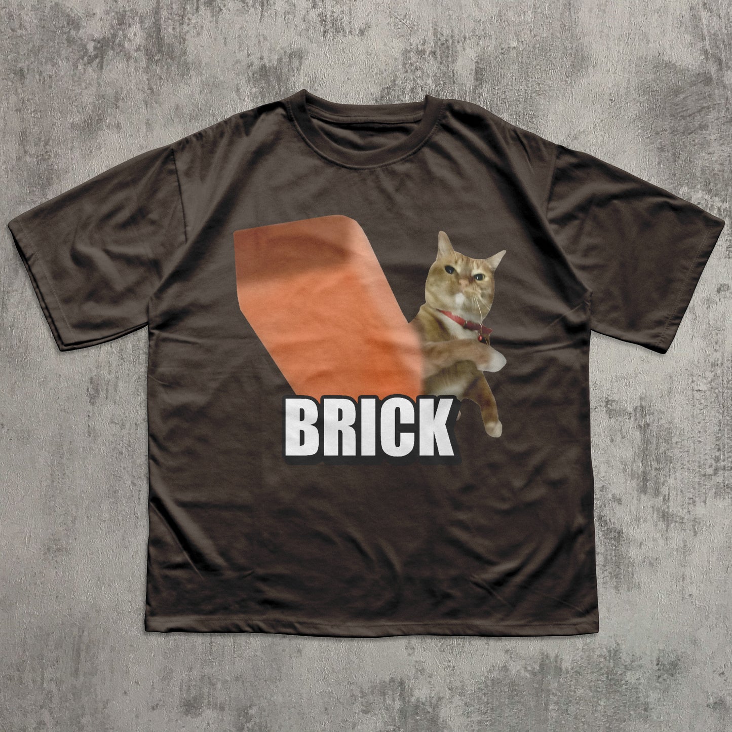 Brown t-shirt with a cat graphic and 'BRICK' text on a textured gray background