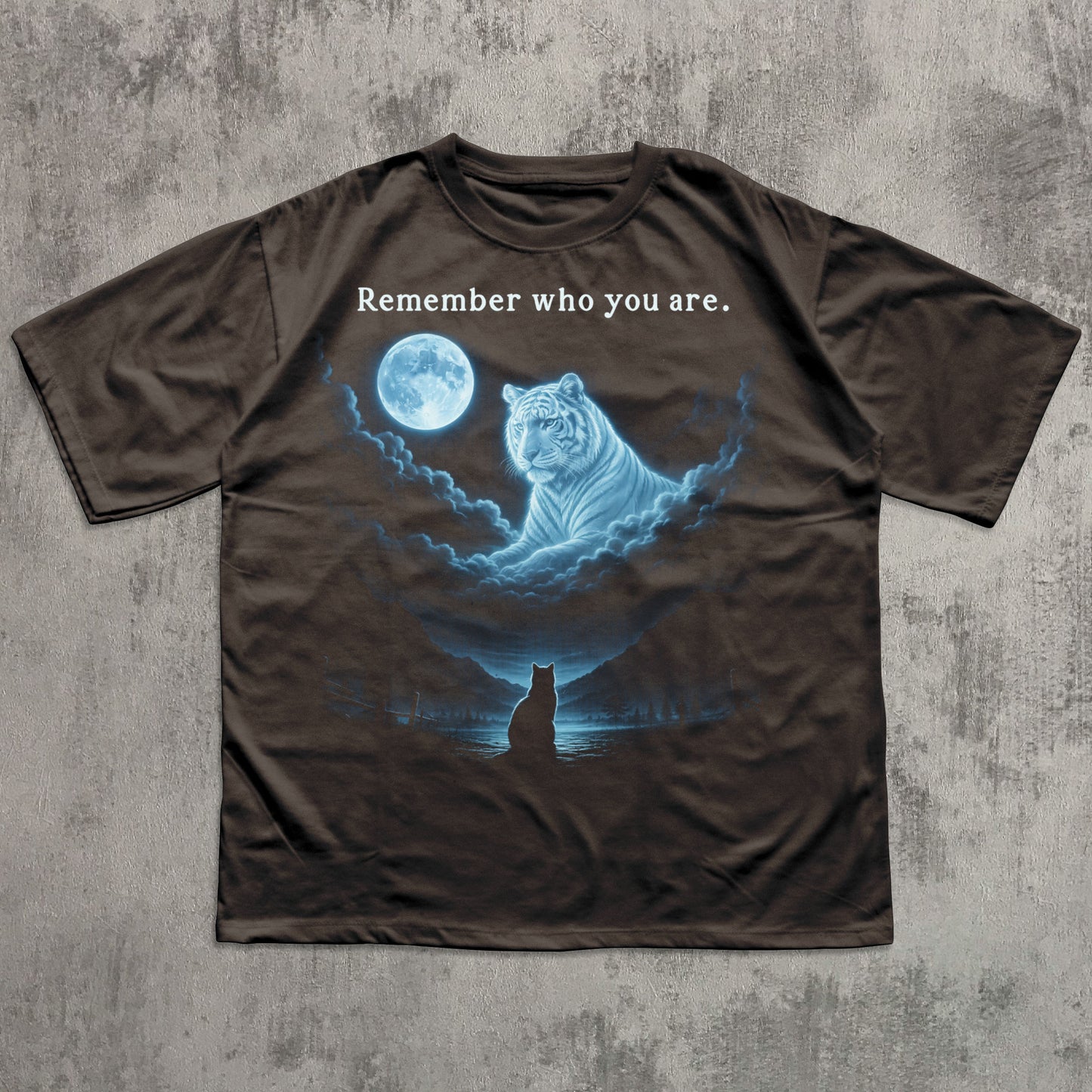 Brown t-shirt with a graphic of a tiger and moon on a concrete surface
