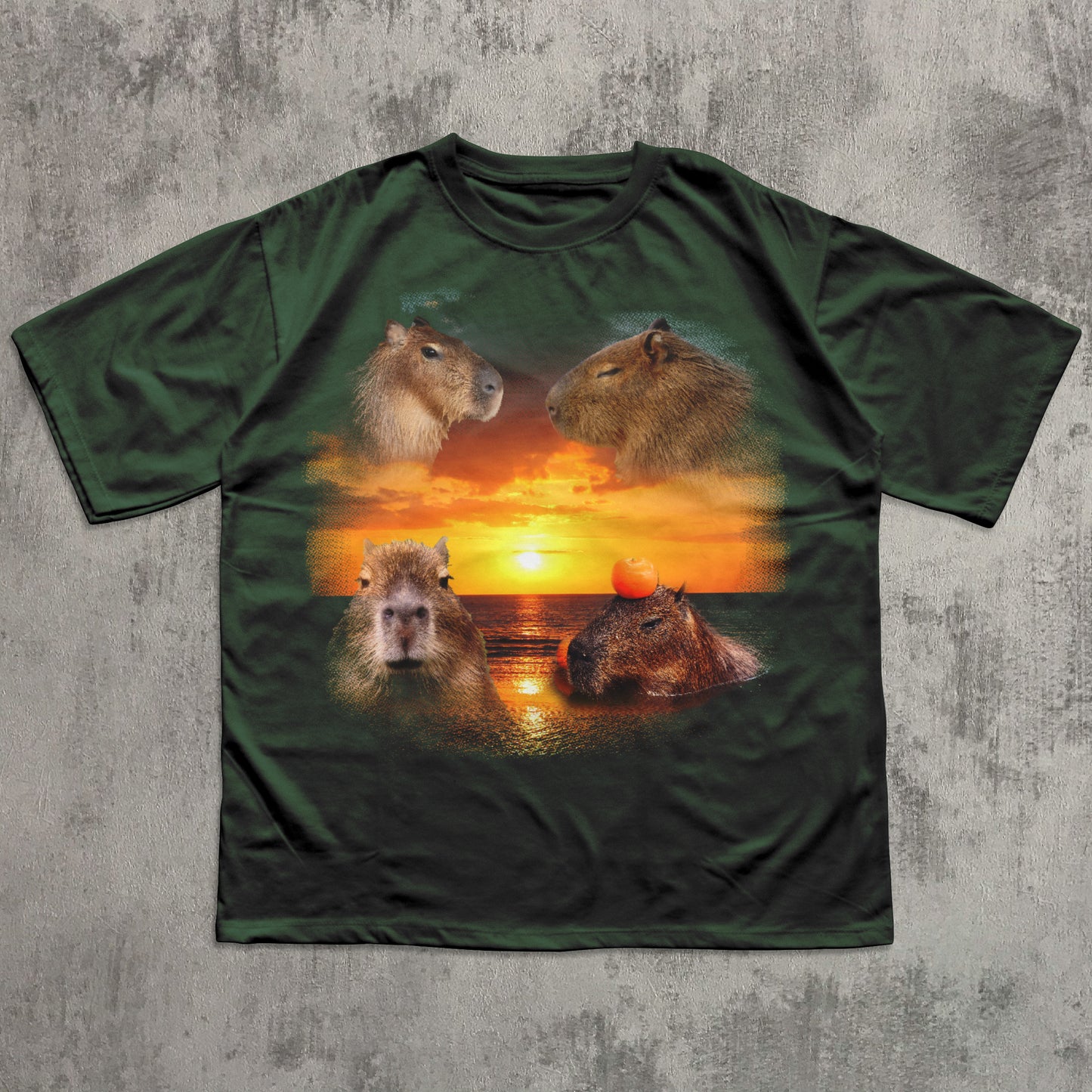 Green t-shirt with capybara design on a sunset background