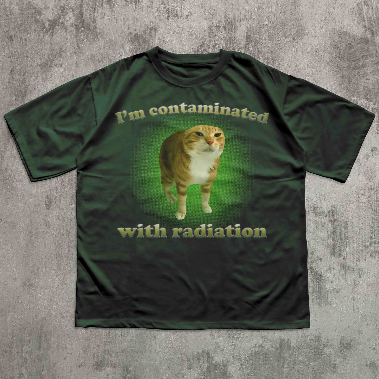 Green t-shirt with a cat graphic and text on a textured gray background