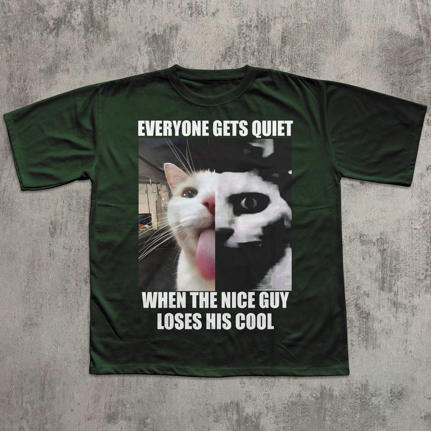 Green t-shirt with a graphic of two cats and text on a concrete surface