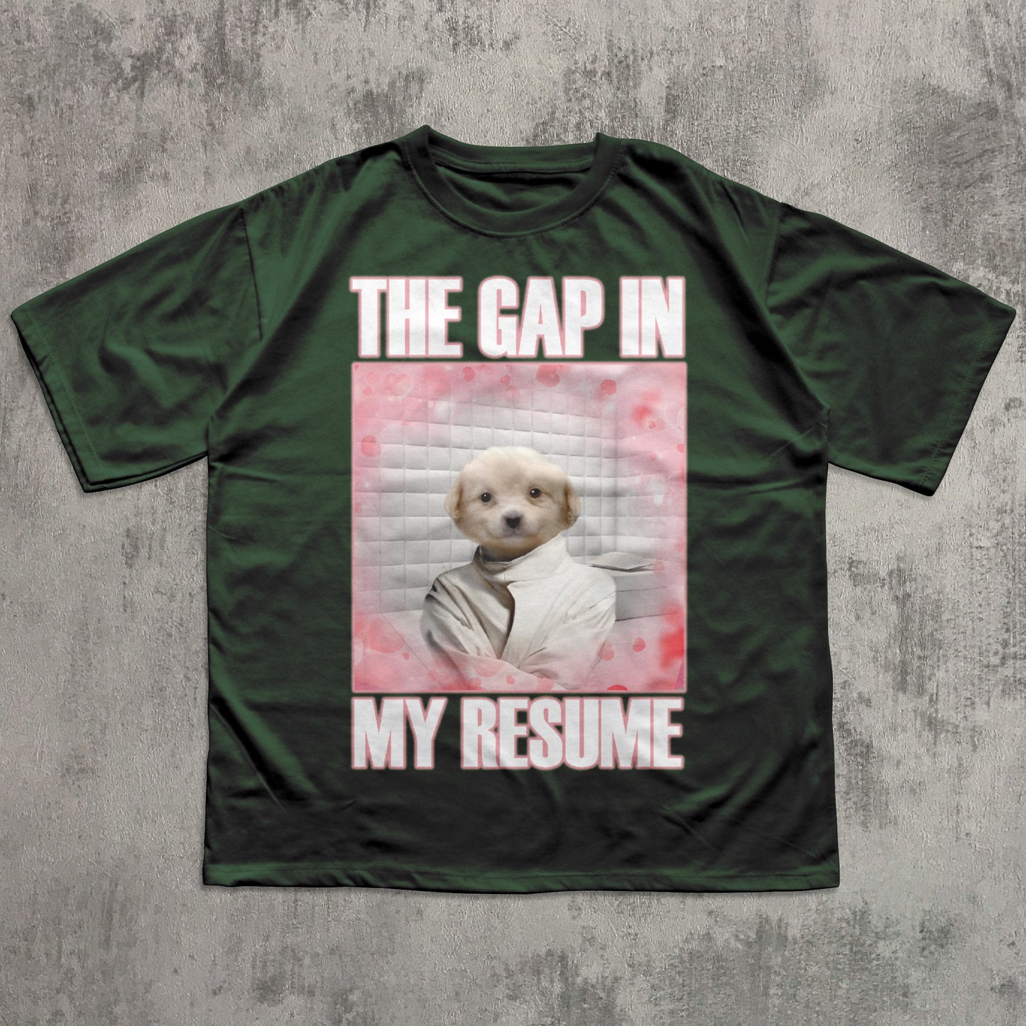 Green t-shirt with a graphic of a dog and text 'The gap in my resume' on a concrete background