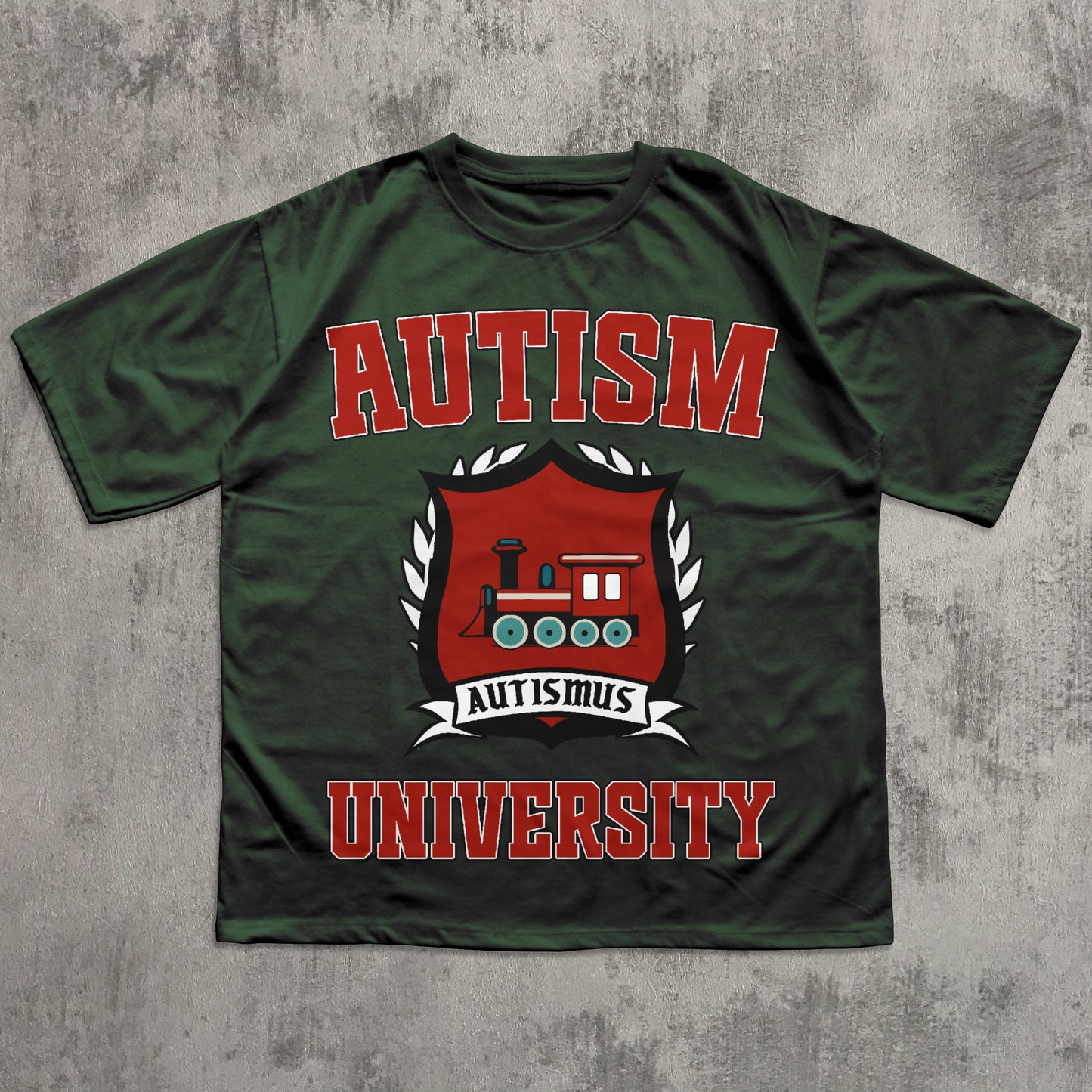 Green t-shirt with 'Autism University' text and train graphic on a textured gray background