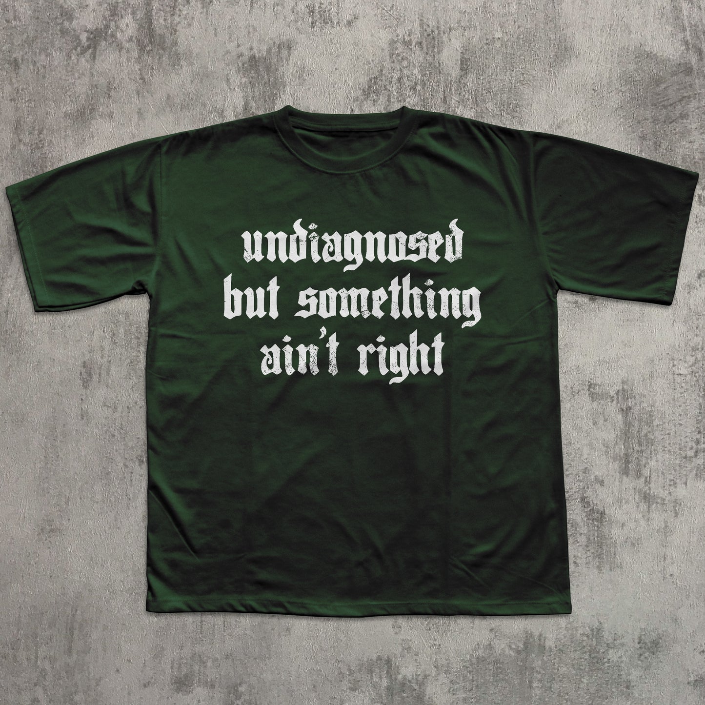 Green t-shirt with white text on a textured gray background