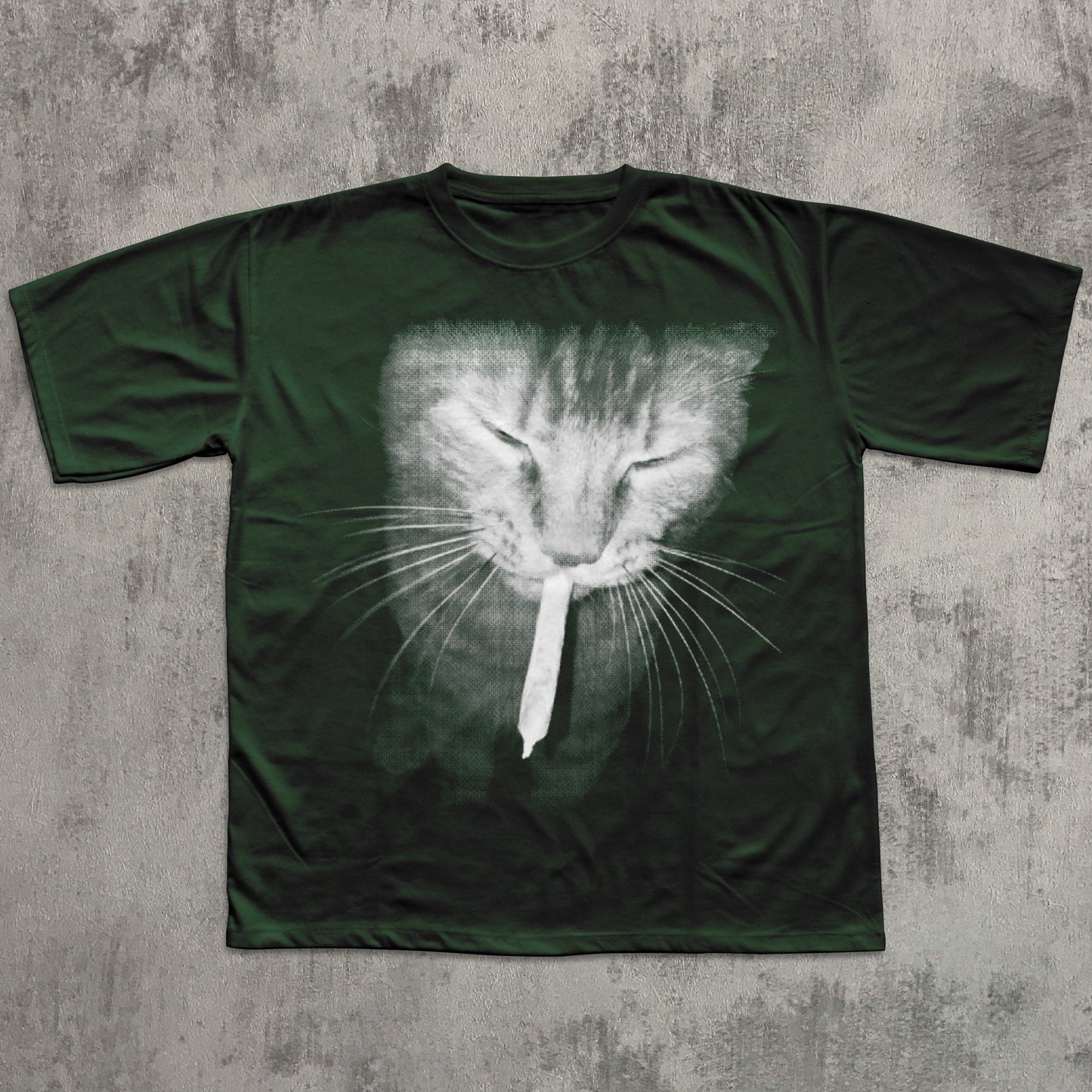 Green t-shirt with a cat face design on a textured gray background