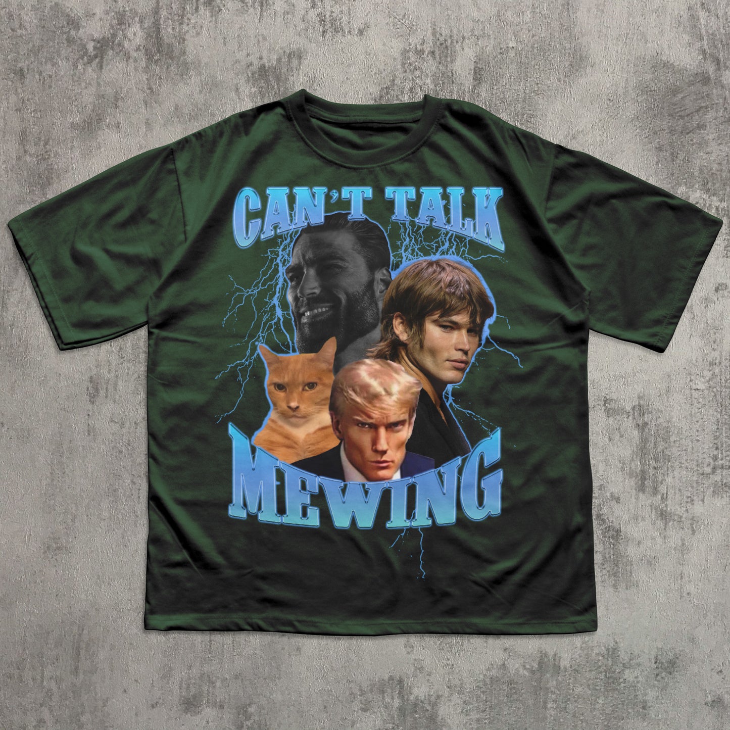 Green t-shirt with graphic design of four people and a cat, text 'CAN'T TALK MEWING', on a textured gray background.