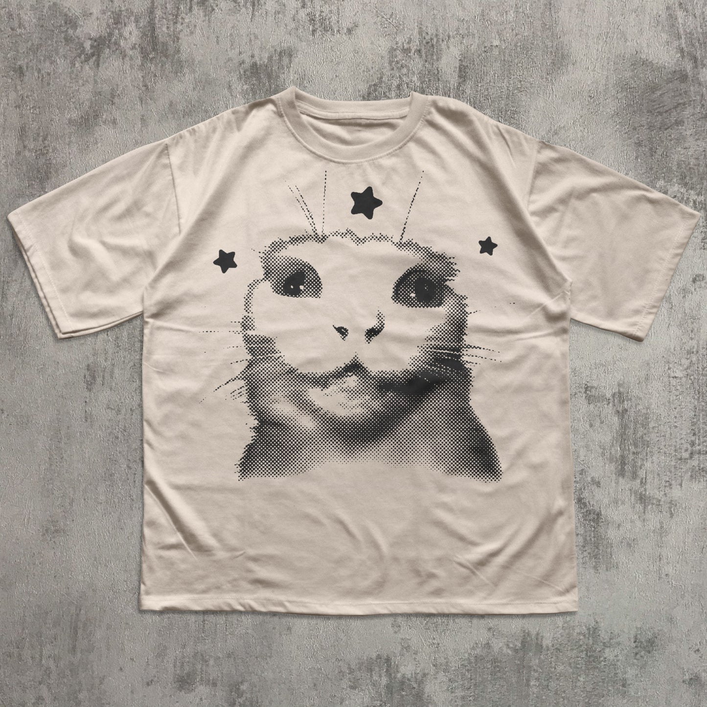 T-shirt with a cat graphic design on a textured gray background