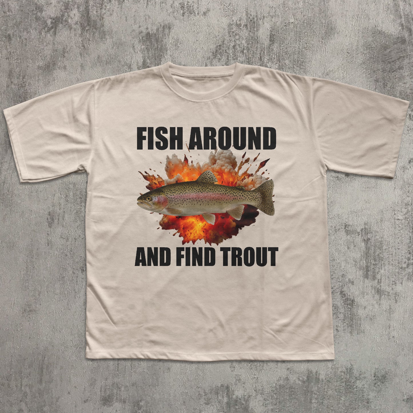 Beige t-shirt with a graphic of a fish and text 'Fish Around and Find Trout' on a textured gray background