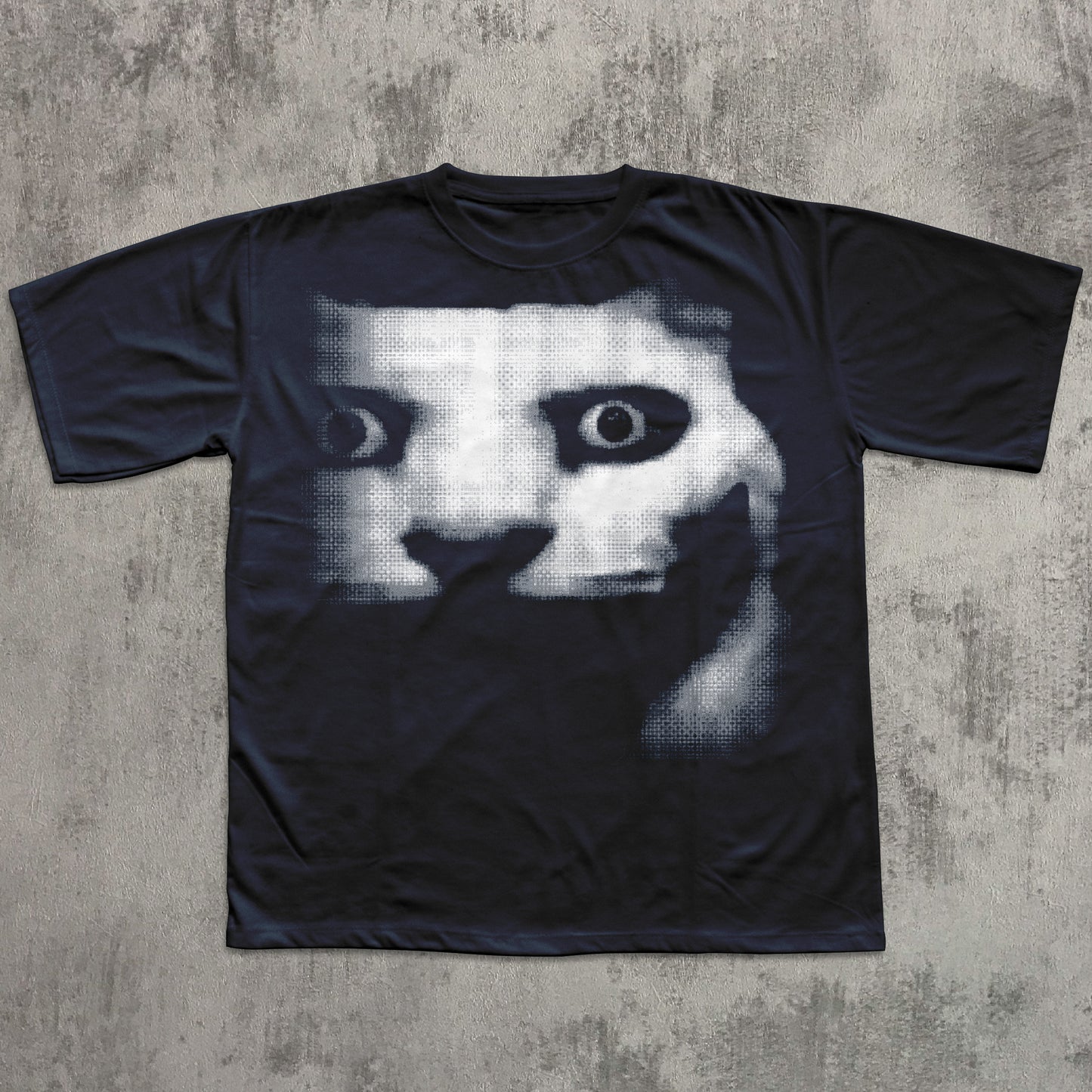 Black t-shirt with a graphic design of a face on a textured gray background