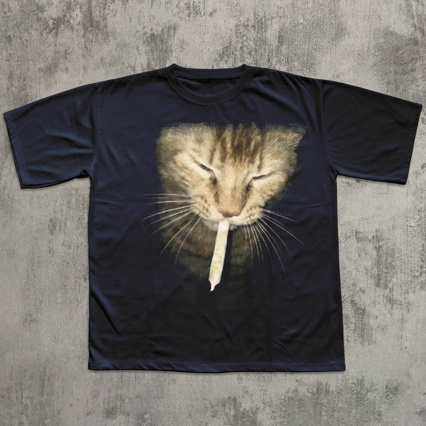 Black t-shirt with a cat graphic on a textured gray surface