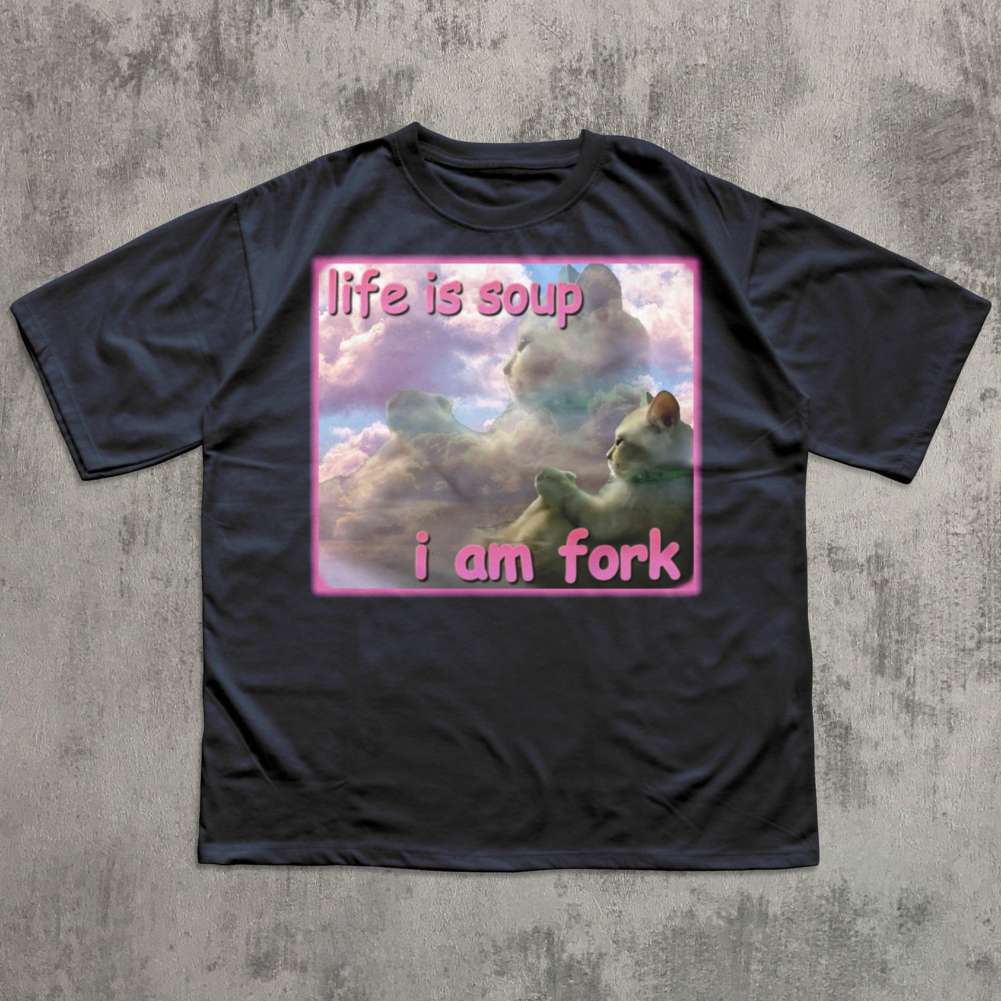 Black t-shirt with a graphic design and text on a textured gray background