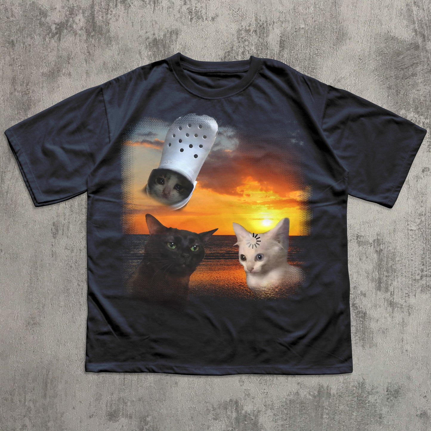 Black t-shirt with a graphic of two cats and a Croc shoe on a sunset background