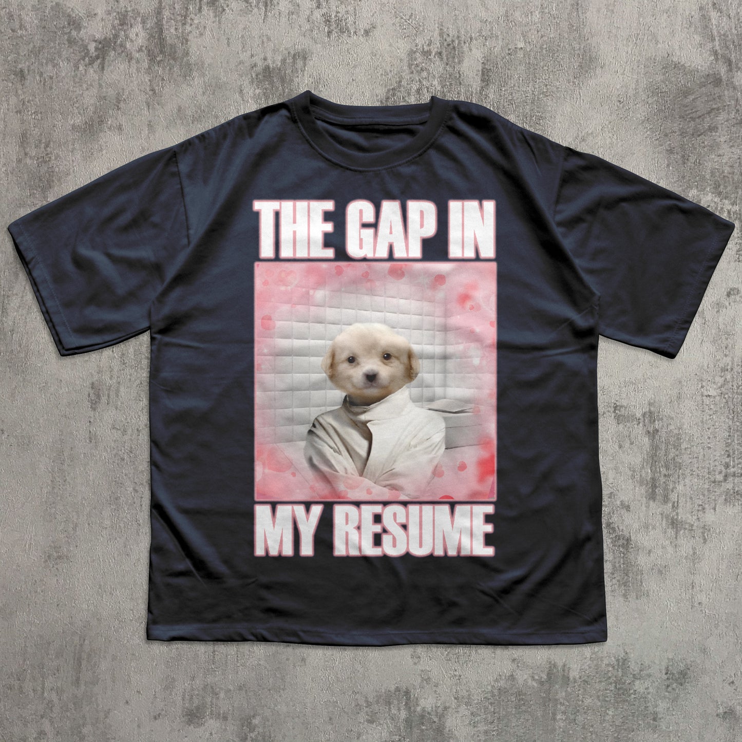 Black t-shirt with a graphic of a dog and text 'The gap in my resume' on a textured gray background