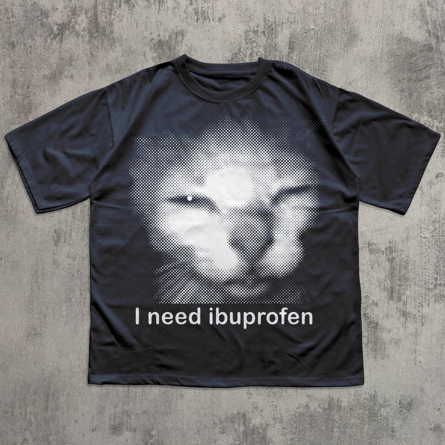 Black t-shirt with a graphic of a cat and text 'I need ibuprofen' on a textured gray background