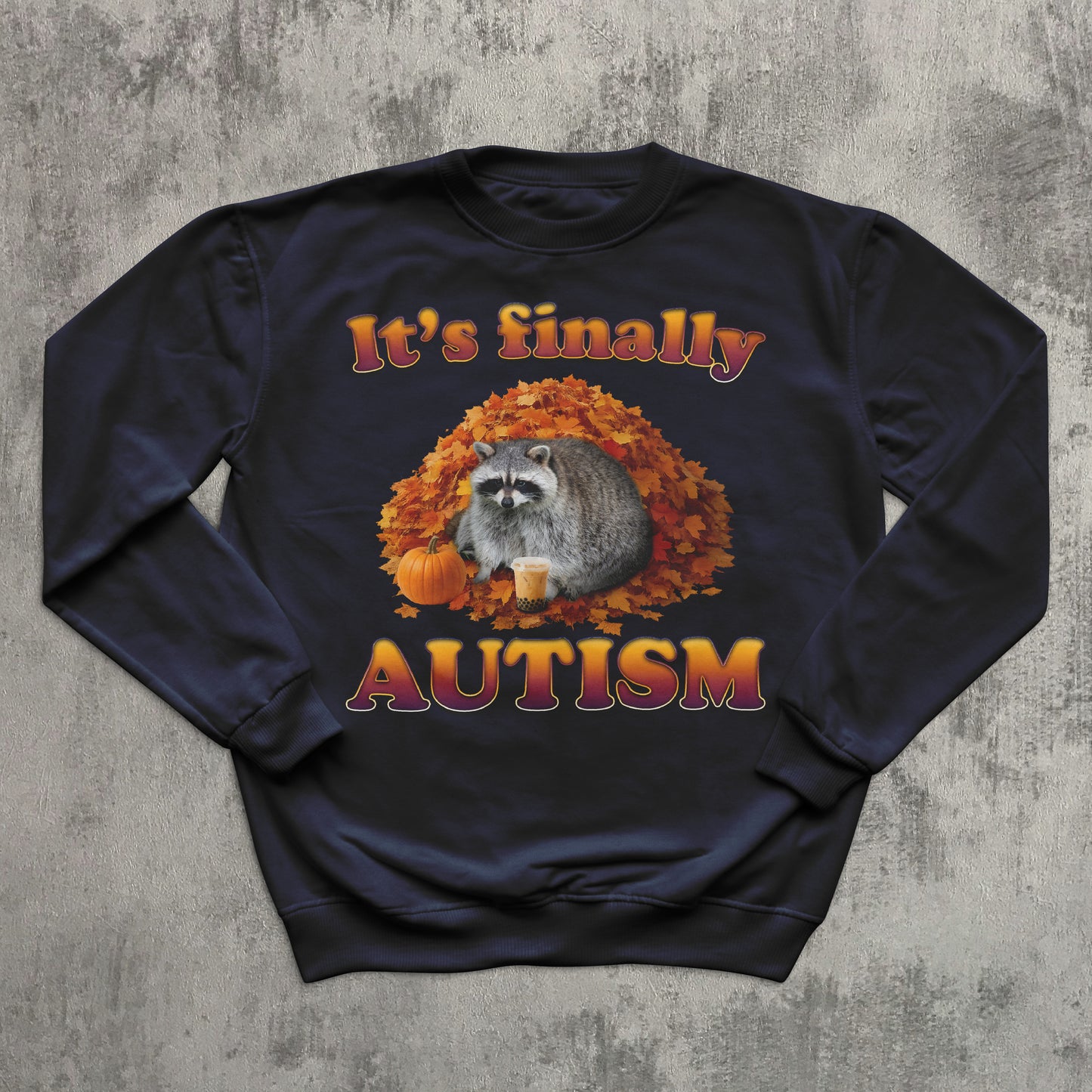 Navy blue sweatshirt with raccoon and autumn design on a textured gray background