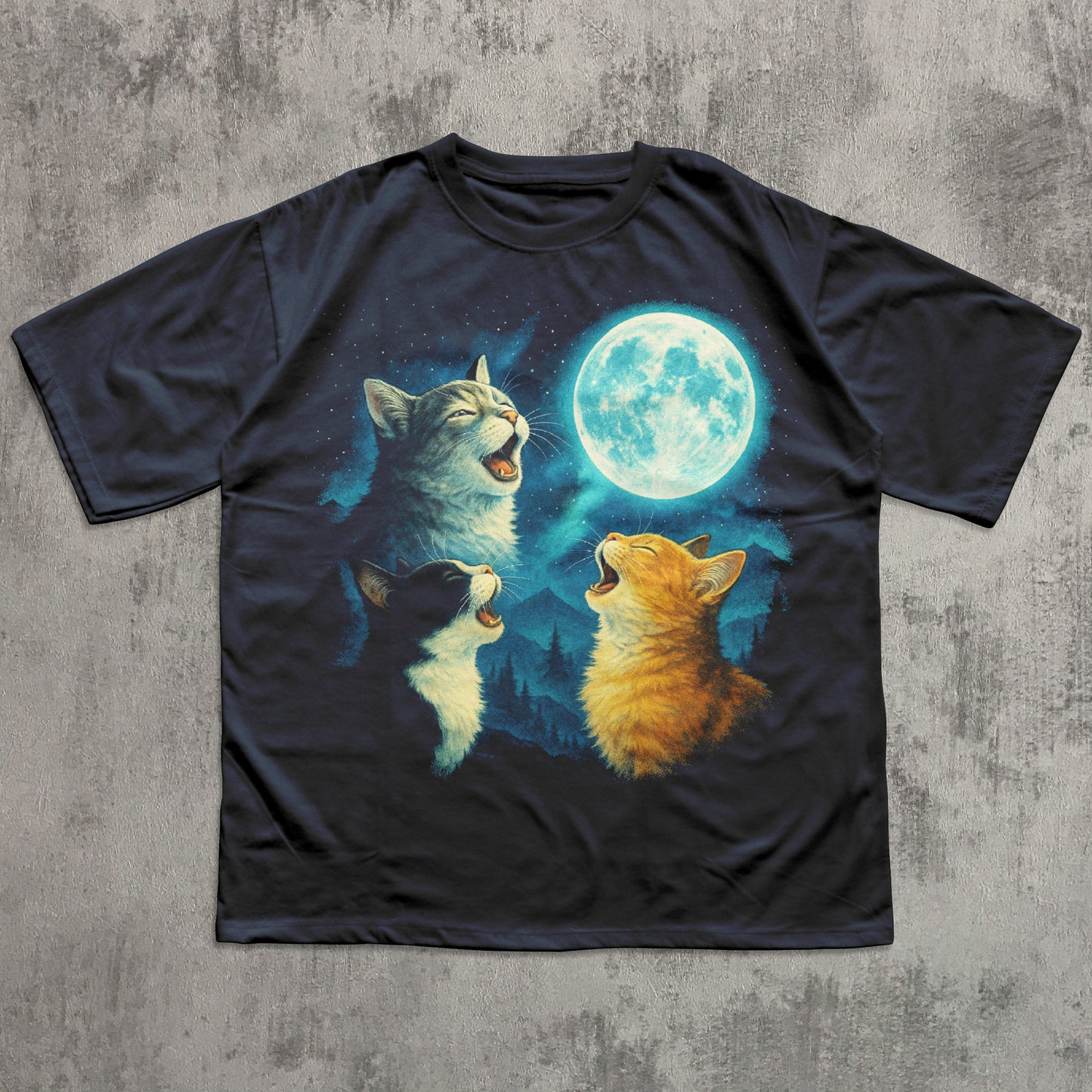 Black t-shirt with a graphic of three cats meowing at a moon on a concrete surface