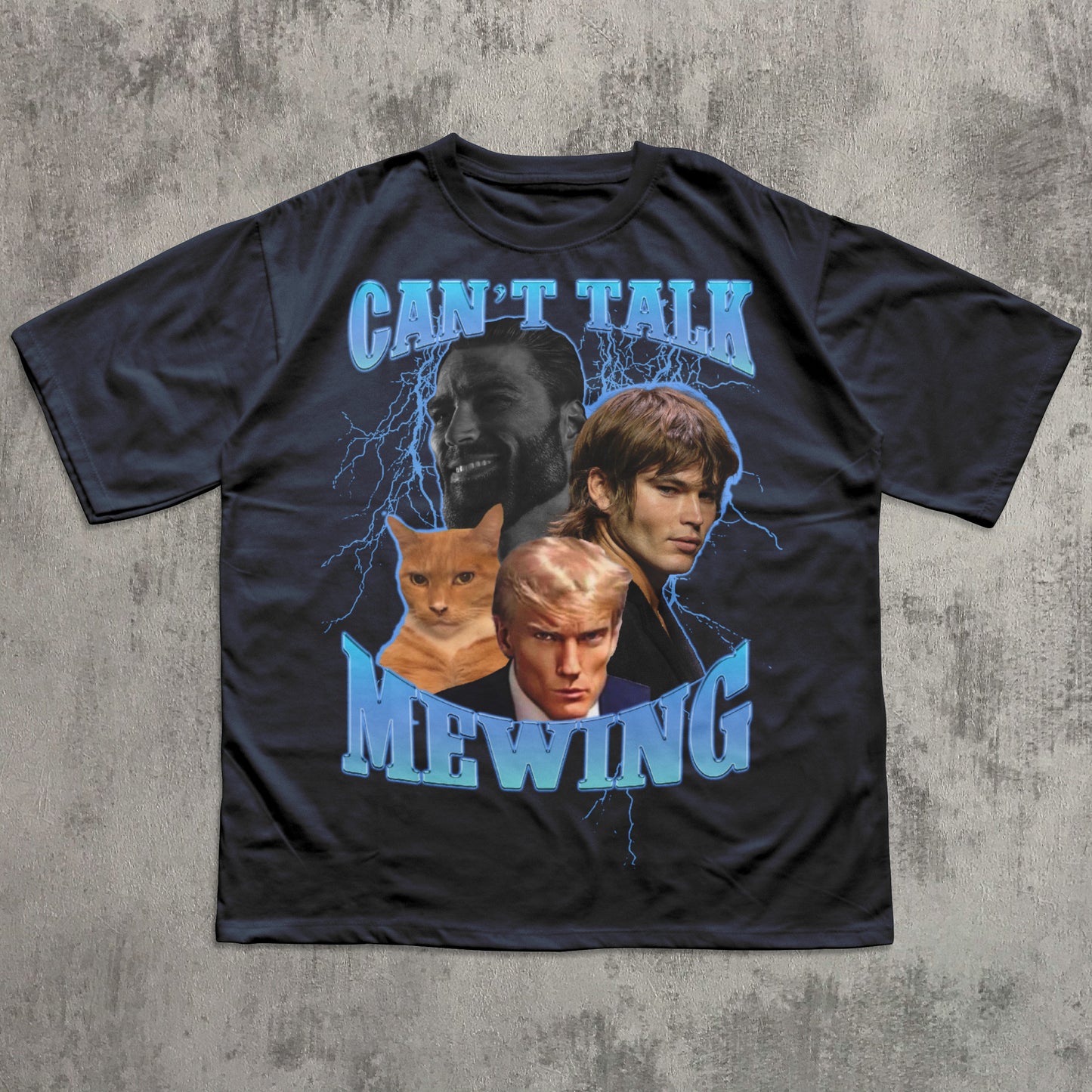 Black t-shirt with graphic design of faces and a cat, text 'CAN'T TALK MEWING', on a textured gray background