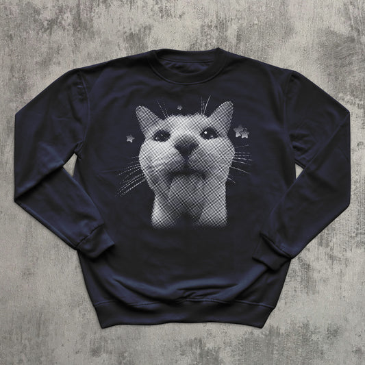Navy blue sweatshirt with a cat graphic on a textured gray background