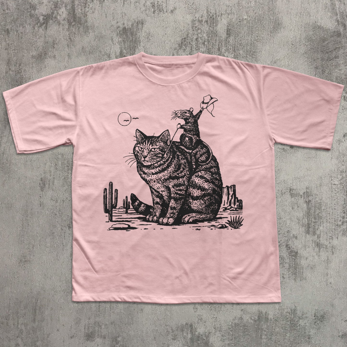 Pink t-shirt with a graphic of two cats on a textured gray background