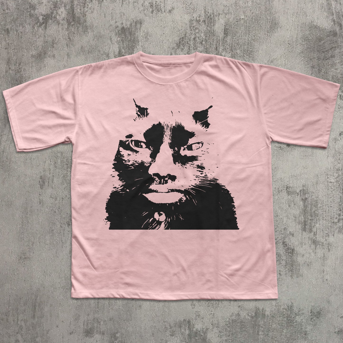 Pink t-shirt with a black cat graphic on a textured gray background