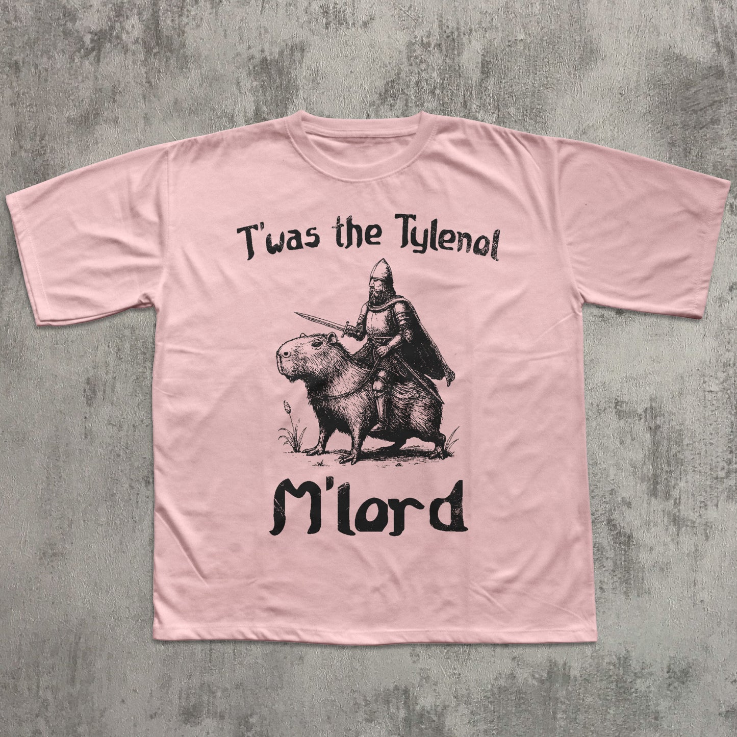 Pink t-shirt with graphic design and text on a textured gray background