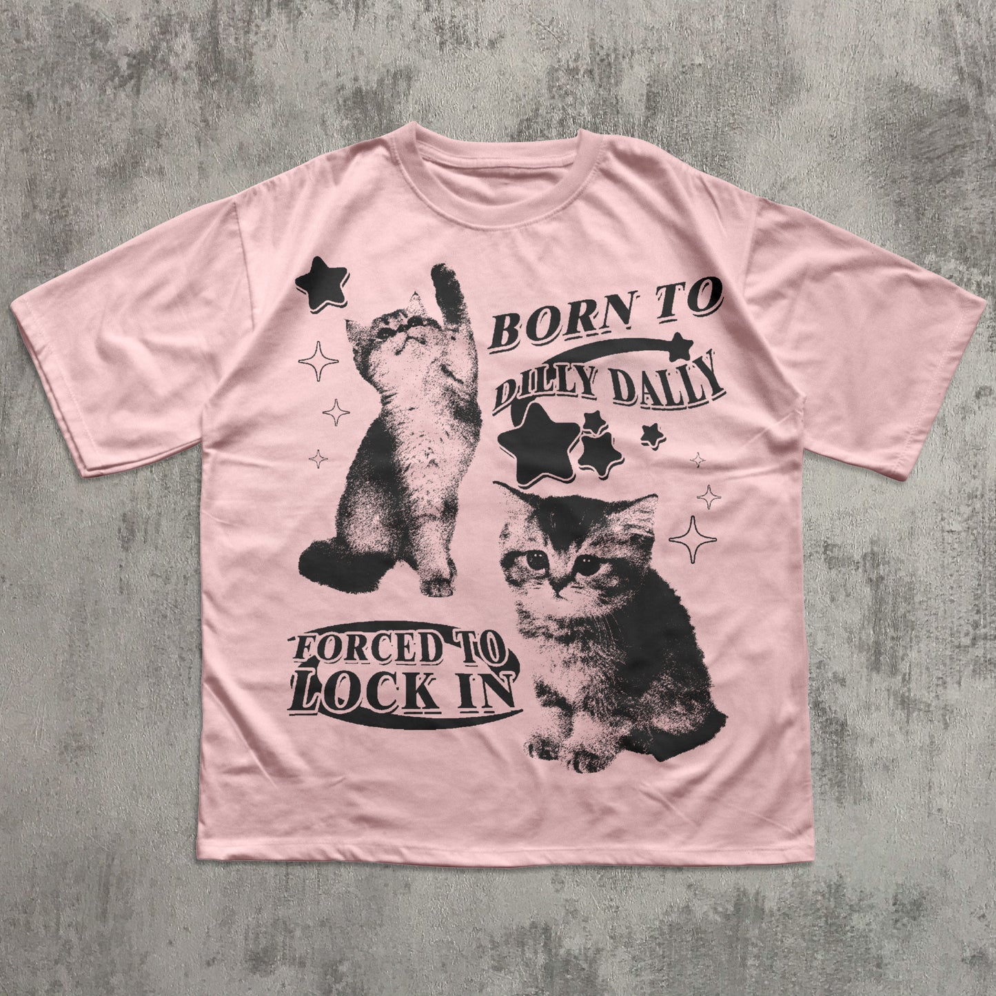 Pink t-shirt with black cat graphics and text on a textured gray background