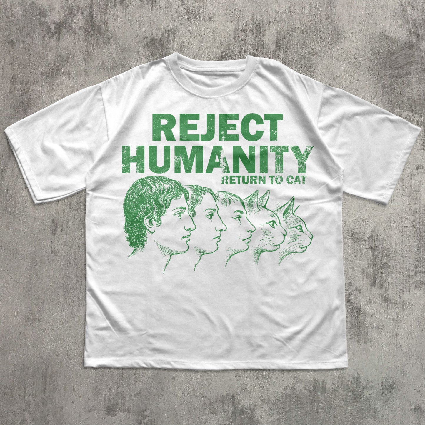 White t-shirt with green text and graphic on a textured gray background